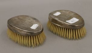Two silver backed brushes. 12.5 cm long.