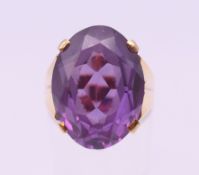 An unmarked gold and amethyst ring. Ring size M/N. 8.6 grammes total weight.