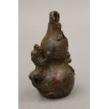 A bronze double gourd. 7 cm high.