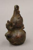 A bronze double gourd. 7 cm high.