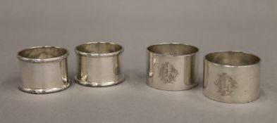 Two cased pairs of silver napkin rings. 198.5 grammes.