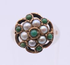 A 9 ct gold turquoise and seed pearl ring. Ring size H.