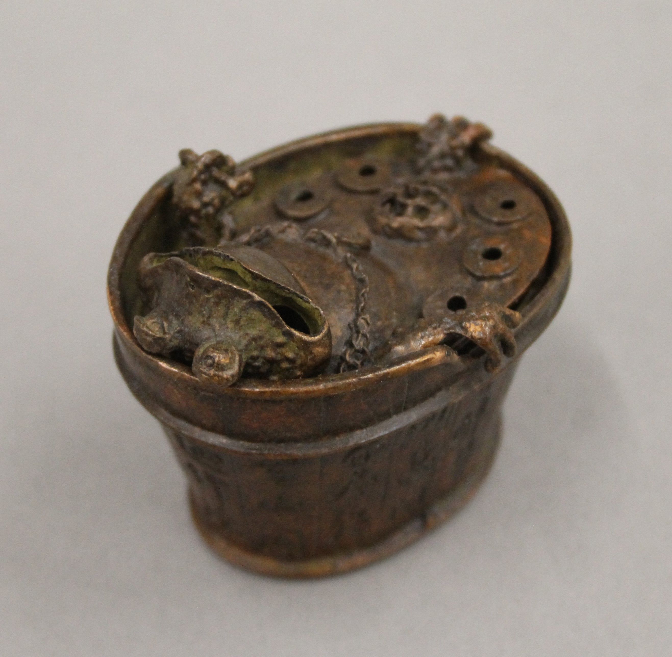 A bronze box formed as a toad in a bath. 5.5 cm high.