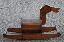 An early 20th century pine hand carved children's rocking horse/dog/duck. 97 cm long.