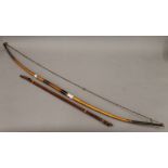 A tribal bow and arrows. The bow 115 cm long.