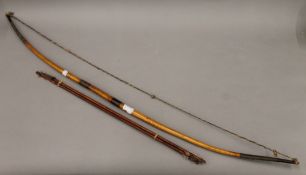 A tribal bow and arrows. The bow 115 cm long.