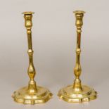 A pair of 18th century brass candlesticks of slender baluster form,