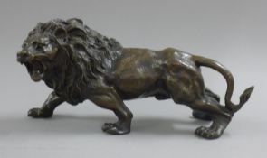 A bronze model of a lion. 14 cm high.