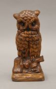A carved wooden model of an owl. 16 cm high.