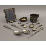 A small silver photograph frame, silver spoons, etc. 224 grammes of weighable silver.