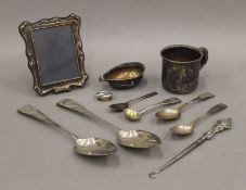 A small silver photograph frame, silver spoons, etc. 224 grammes of weighable silver.