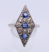 An 18 ct gold and platinum diamond and sapphire ring. Ring size Q/R. 4.2 grammes total weight.