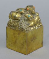A Chinese gilt bronze seal formed as rams. 9.5 cm high.