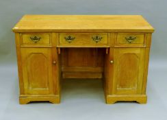 A Victorian oak desk. 122.5 cm long.