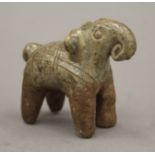 An antique Indian ceramic elephant with incised decoration. 8 cm long.