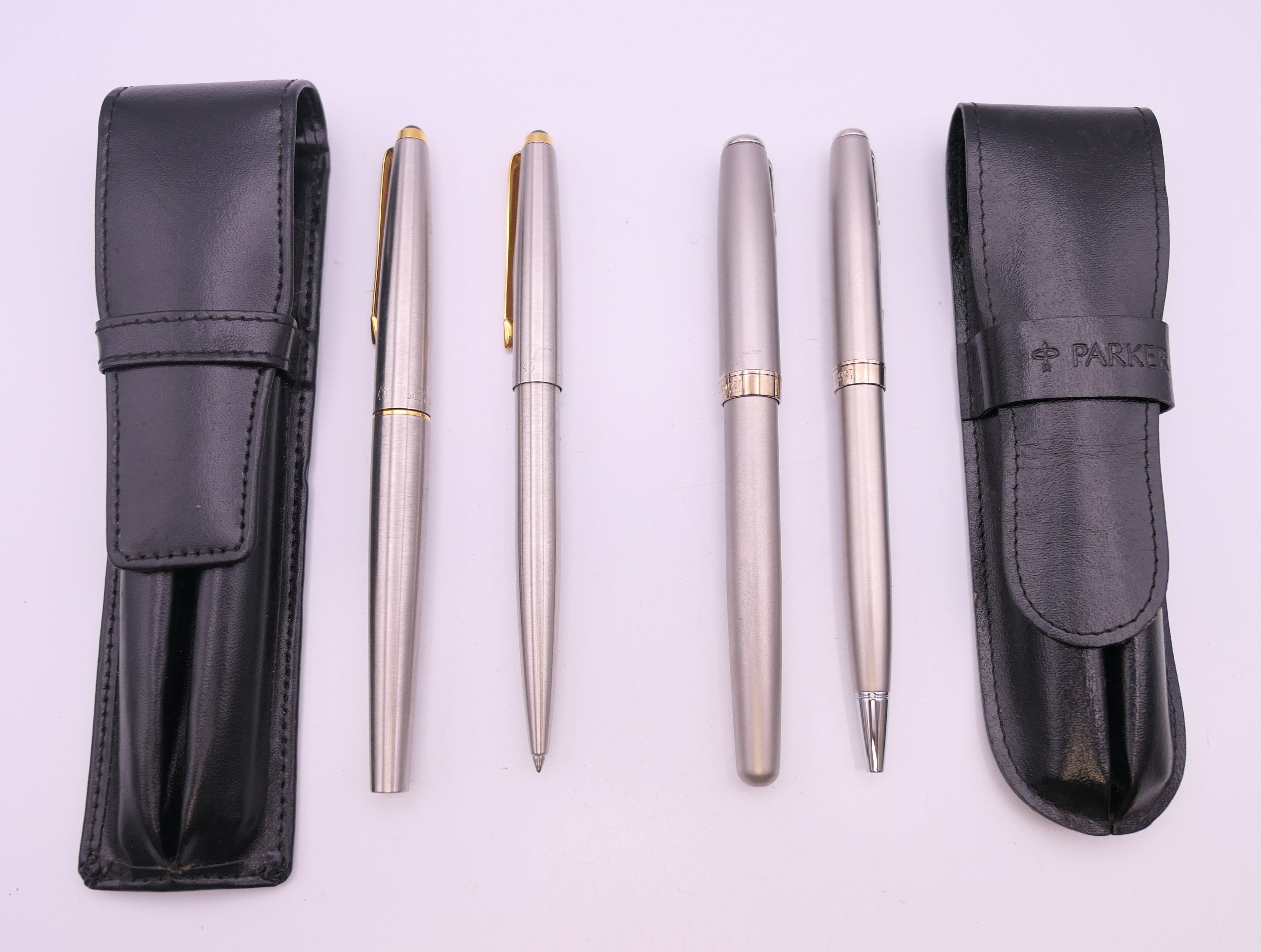 Four various Parker pens.