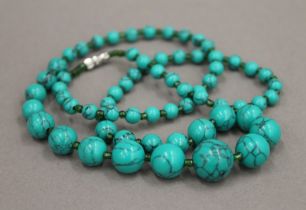 A string of turquoise beads. 61 cm long.