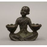 A bronze model of a boy with lilies. 5.5 cm high.