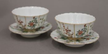 A pair of Chinese tea bowls and saucers,