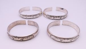 Four Chinese white metal bangles.
