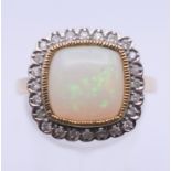 A 9 ct gold opal and diamond ring. Ring size O/P. 4.7 grammes total weight.