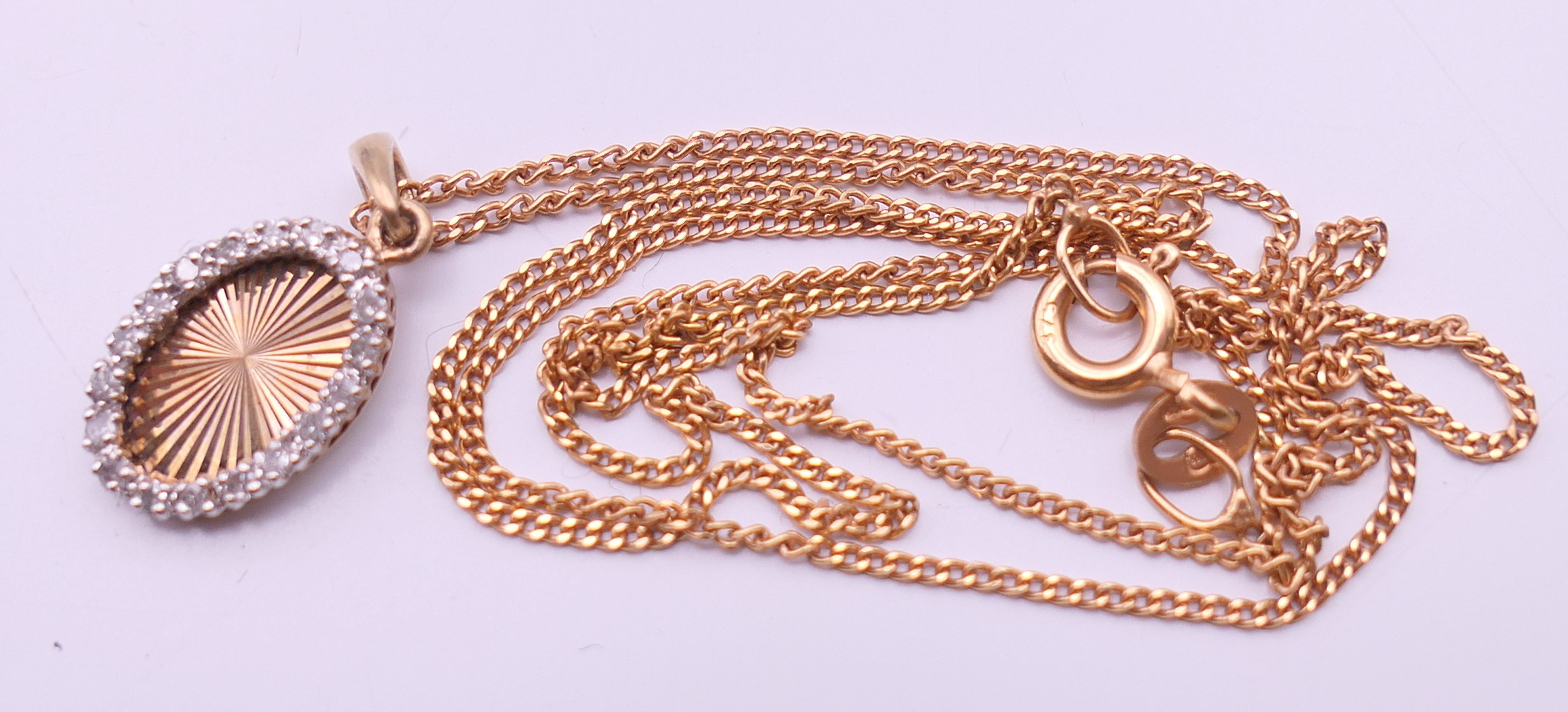 A 9 ct gold and diamond oval pendant on a 9 ct gold chain. Pendant 1. - Image 10 of 10