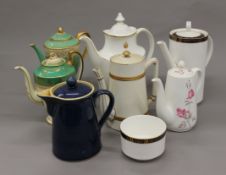 A collection of porcelain tea and coffee pots.