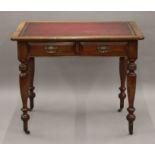 A Victorian leather topped two drawer writing table. 91 cm wide.