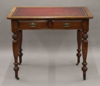 A Victorian leather topped two drawer writing table. 91 cm wide.