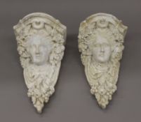A pair of wall mounted plaster busts. 27 cm high.