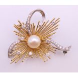 An 18 ct gold pearl and diamond brooch. 4.5 cm x 4 cm. 11.7 grammes total weight.