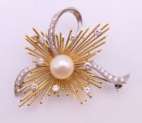 An 18 ct gold pearl and diamond brooch. 4.5 cm x 4 cm. 11.7 grammes total weight.