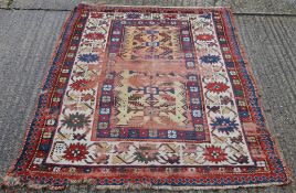 A Caucasian red ground wool rug. 142 x 220 cm.