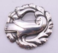 A vintage Georg Jensen circular silver brooch with dove design, numbered 165. 4 cm wide.