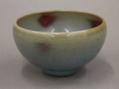 A Chinese Jun Ware red splash bowl, Song Dynasty. 8 cm diameter.