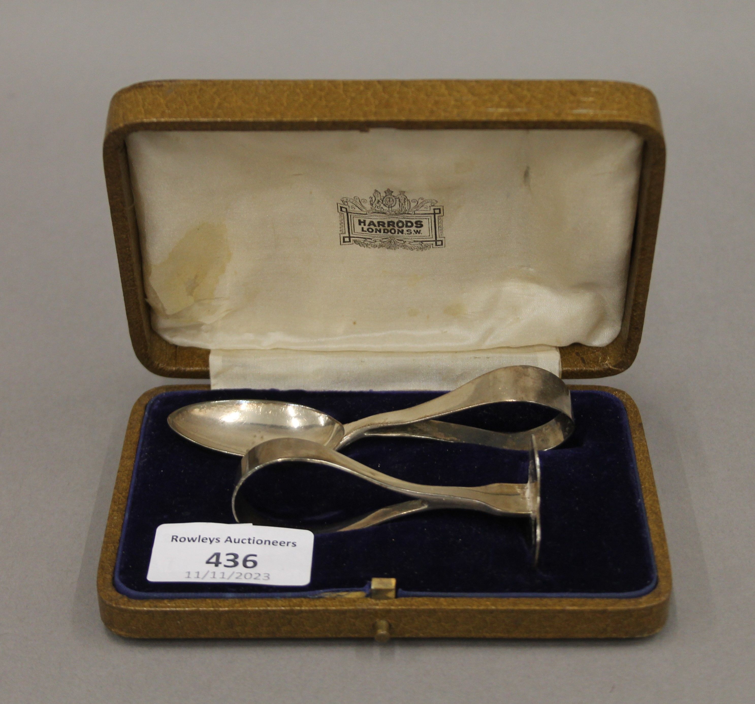 A silver baby spoon and pusher, in Harrods box. The box 13.5 cm long.