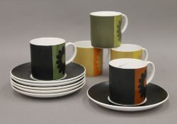 Five Susie Cooper cups and six Susie Cooper saucers. The cups 6.5 cm high.