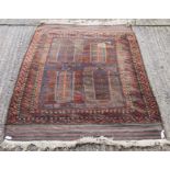 A Caucasian red ground wool rug. 118 x 192 cm.
