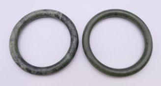 A pair of russet green jade bangles. The largest 6 cm interior diameter.