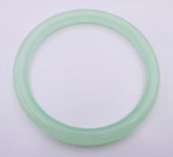 An icy celadon jade bangle. Approximately 6 cm interior diameter.