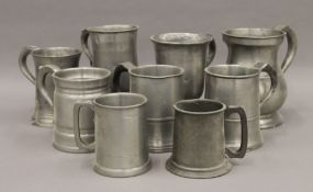A quantity of various pewter tankards. The largest 16 cm high.