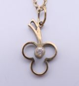 A small 9 ct gold pendant on a 9 ct gold chain. The pendant 1.5 cm high. 1.8 grammes total weight.
