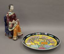 A Chinese porcelain figure and a Japanese porcelain plate. The former 26 cm high.