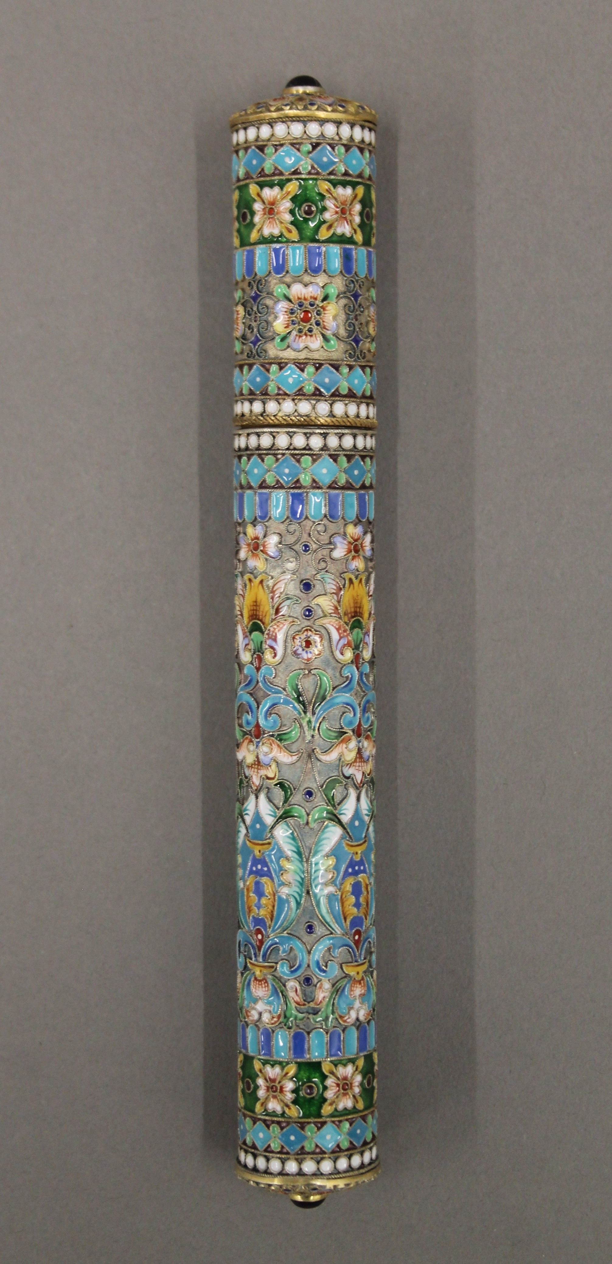An enamelled decorated silver gilt cigar holder, bearing Russian marks. 19 cm long.
