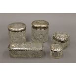 Five silver topped dressing table jars. The largest 9 cm long.