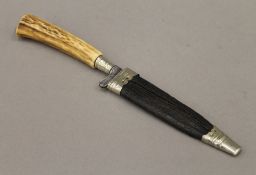 A 19th century horn handled hunting knife with steel blade and leather scabbard. 27 cm long.