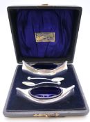 A pair of novelty silver salts of canoe shape with paddle form spoons, Birmingham 1906, boxed.