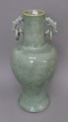 A Chinese celadon vase with ring handles. 55 cm high.