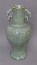 A Chinese celadon vase with ring handles. 55 cm high.