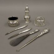 Seven silver and silver mounted items, comprising of a pepperette, two salts, a button hook,